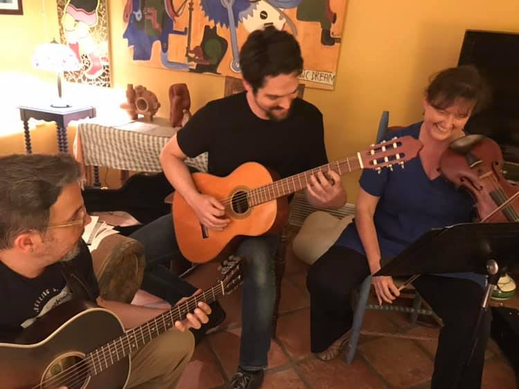 image of Camerata Sonora rehearsing with guitars and violin